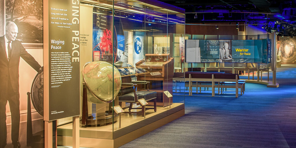 A display inside the Eisenhower museum, featuring informational panels with photos and text about historical events and figures.