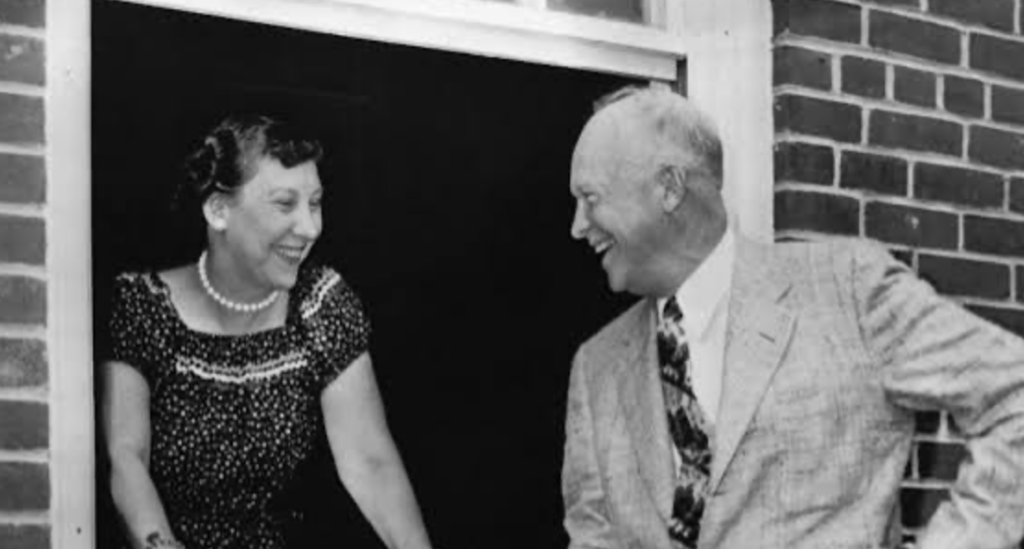 Dwight D. Eisenhower and Mamie Eisenhower smiling at each other.