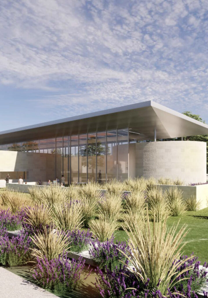 Modern architectural building with a glass and steel exterior under a blue sky.