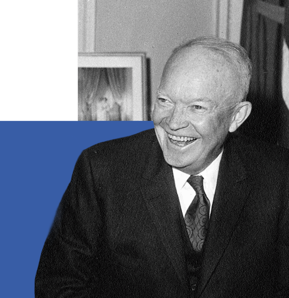 This is a black and white photograph of Dwight D. Eisenhower dressed in formal attire. He appears to be speaking, as suggested by his open mouth and slight smile.