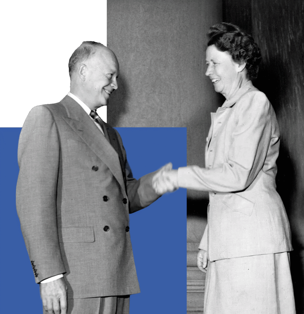 Dwight D. Eisenhower and woman shaking hands, both dressed in formal outfits.