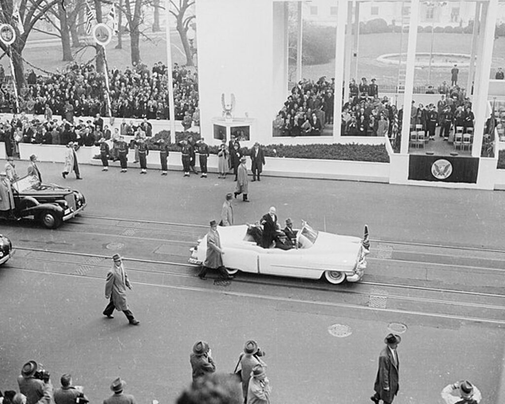 A president riding in a car during his inauguration parade.