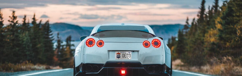 High-performance sports car on a road at dusk.