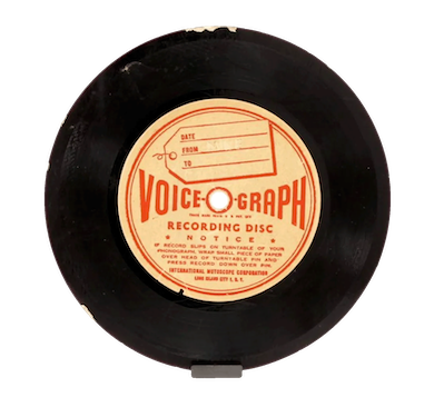 This image shows a vinyl record. The text on the label reads "VOICEGRAPH RECORDING DISC."