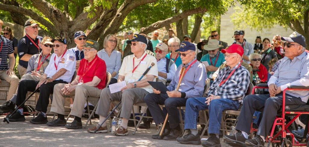 Attendees seated outdoors during a public event.