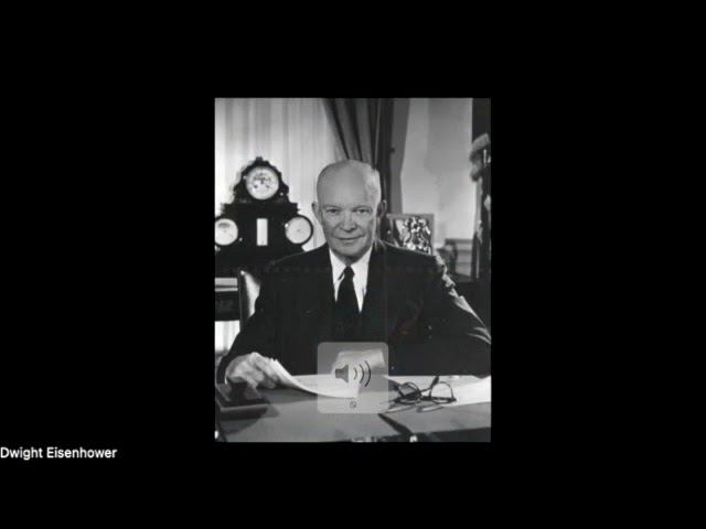President Dwight Eisenhower in a suit at his desk.