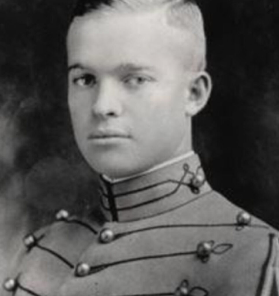 A black-and-white photograph featuring a young Dwight D. Eisenhower in a military uniform posing for a portrait. The uniform is complete with buttons and a collar. He appears to be looking at the camera.
