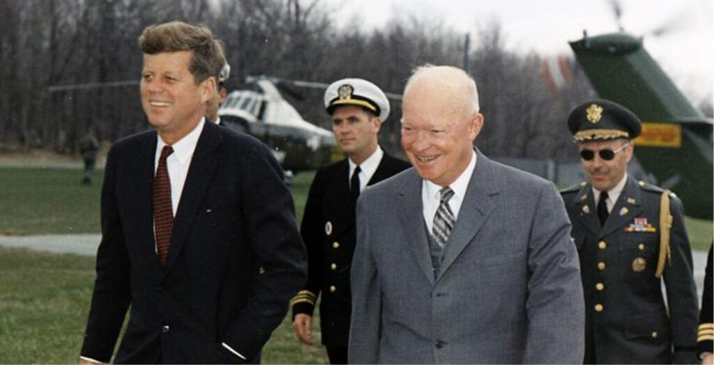 President John F. Kennedy and Dwight D. Eisenhower in a shared photo opportunity at an airport runway.