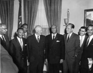 Black-and-white group portrait of President Eisenhower, Martin Luther King, and other men in suits.