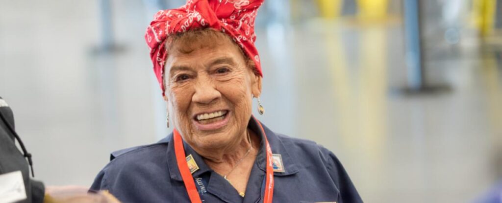 Portrait of Connie Palacioz wearing a red patterned headscarf.