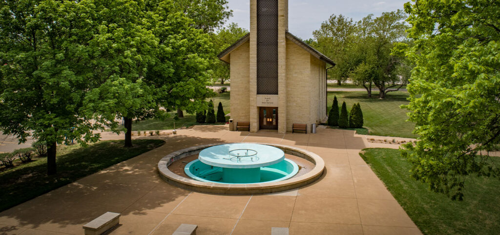 Circular fountain in a landscaped courtyard.