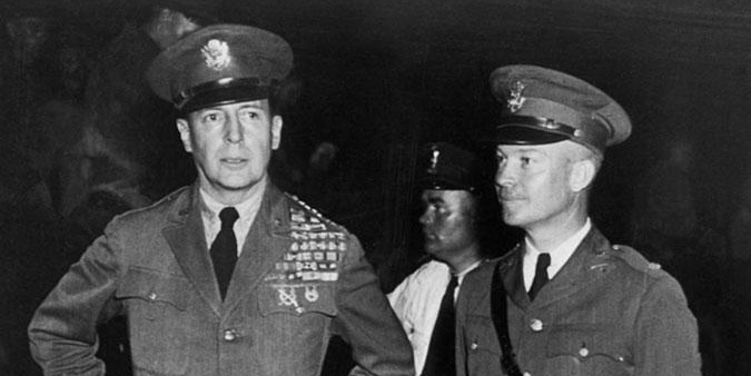 Dwight D. Eisenhower and Macarthur in military uniforms, standing side by side.