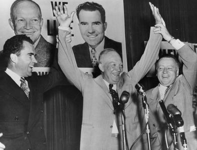 Nixon and Ike standing in front of a group of microphones during a political event.