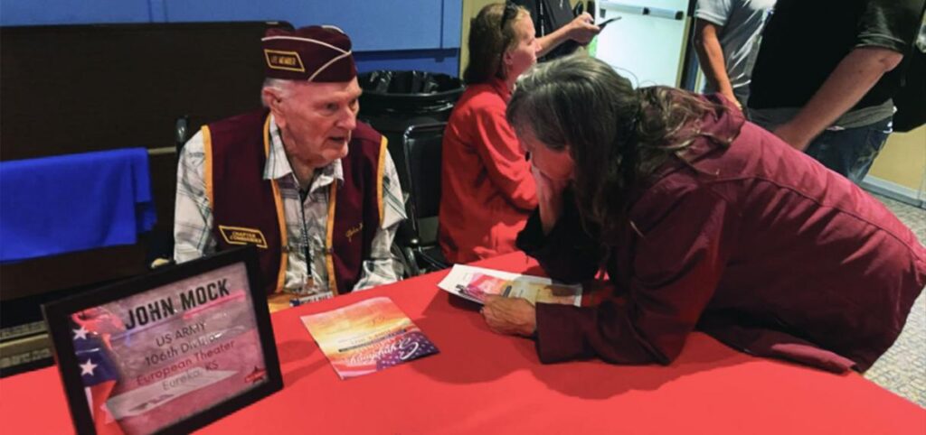Veteran seated at a table during a reception.