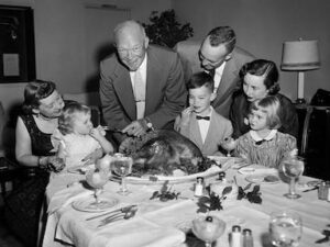 Eisenhower family gathered around a table for a Thanksgiving meal.