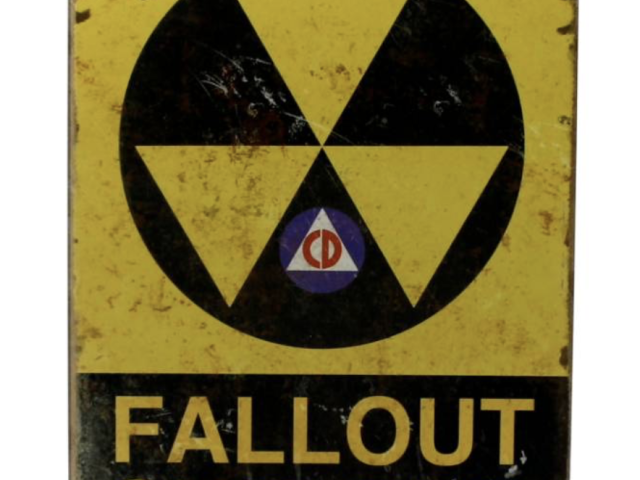 Yellow and black fallout shelter sign with the civil defense symbol.