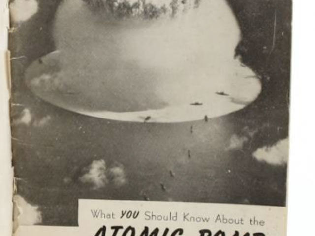 Large mushroom cloud rising after a nuclear explosion.