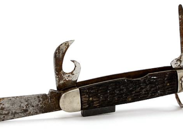 Folding pocketknife with a dark handle and curved metal blade.