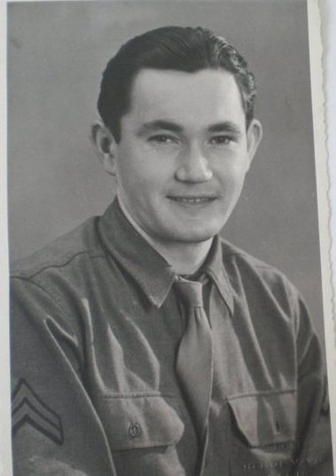 Young serviceman smiling in a formal military portrait.