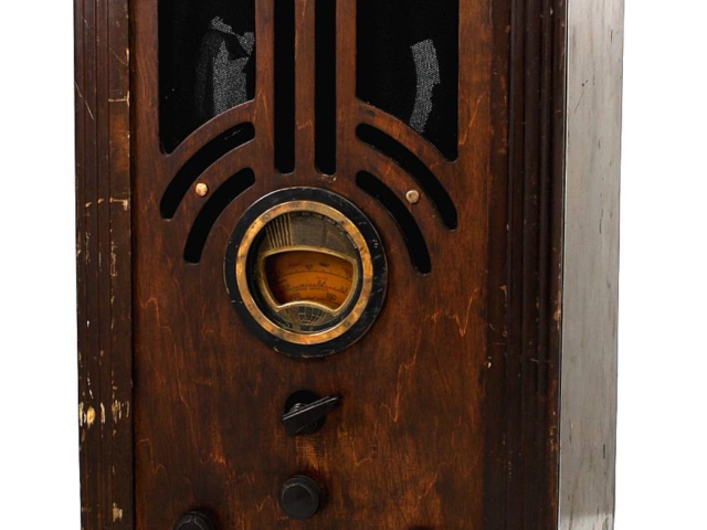 Vintage Philco tombstone radio with an arched wooden cabinet and circular tuning dial.