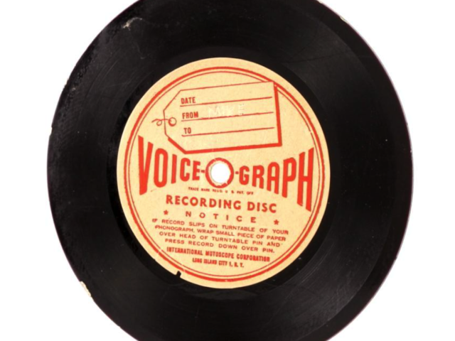 Black Voice-O-Graph recording disc with an orange center label.