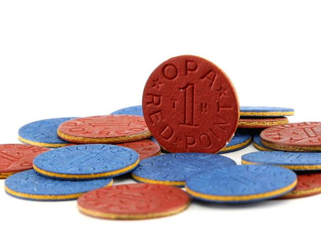 Red and blue World War II ration tokens, including a red OPA token marked “1 red point.”
