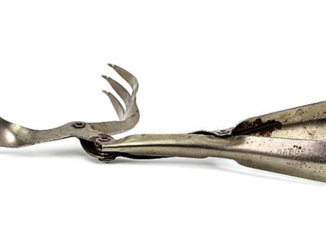 Metal canning jar lifter with curved gripping ends.