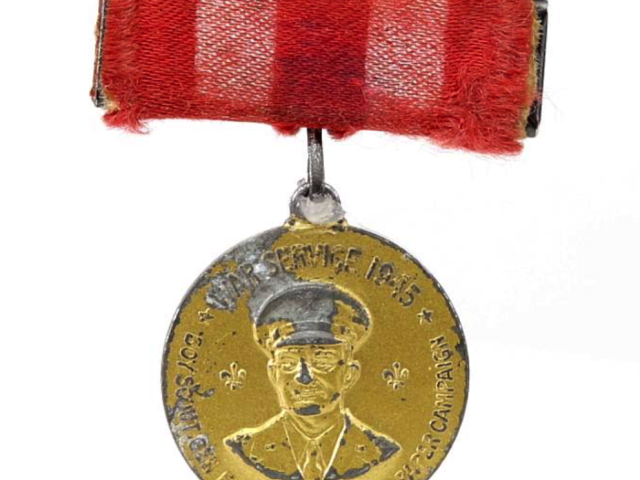 1945 war service medal suspended from a red ribbon.