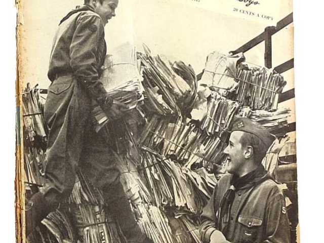 Boys’ Life magazine cover showing a young man examining military equipment.