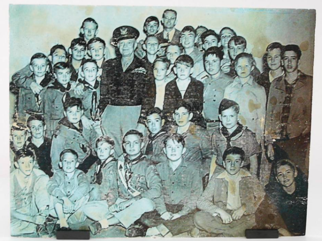 General Dwight D. Eisenhower posing with a large group of Boy Scouts.