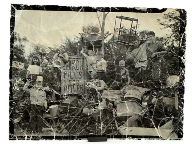 Wartime poster showing soldiers and military equipment beneath the slogan “Iron pills for Hitler.”