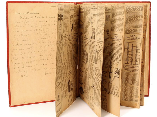 Open Victory Garden scrapbook filled with handwritten notes and clippings.