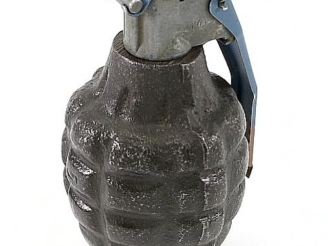 Close-up of a segmented military hand grenade commonly called a pineapple grenade.