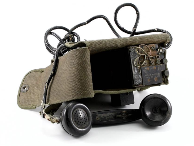U.S. Army field telephone with its carrying bag and attached cables.
