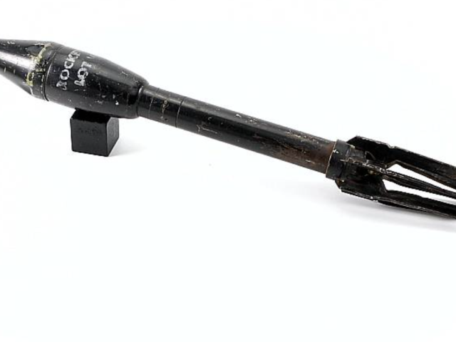 Bazooka rocket with a long black body and metal components.