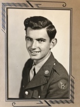 This is an old photo of a man in military uniform wearing a tie and posing for the camera.