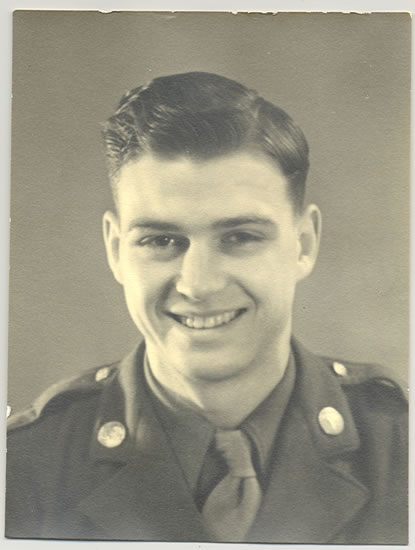 A man in military uniform smiling at the camera.