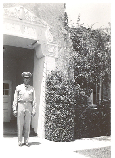 Lawrence Altmann standing outside a building in military uniform.