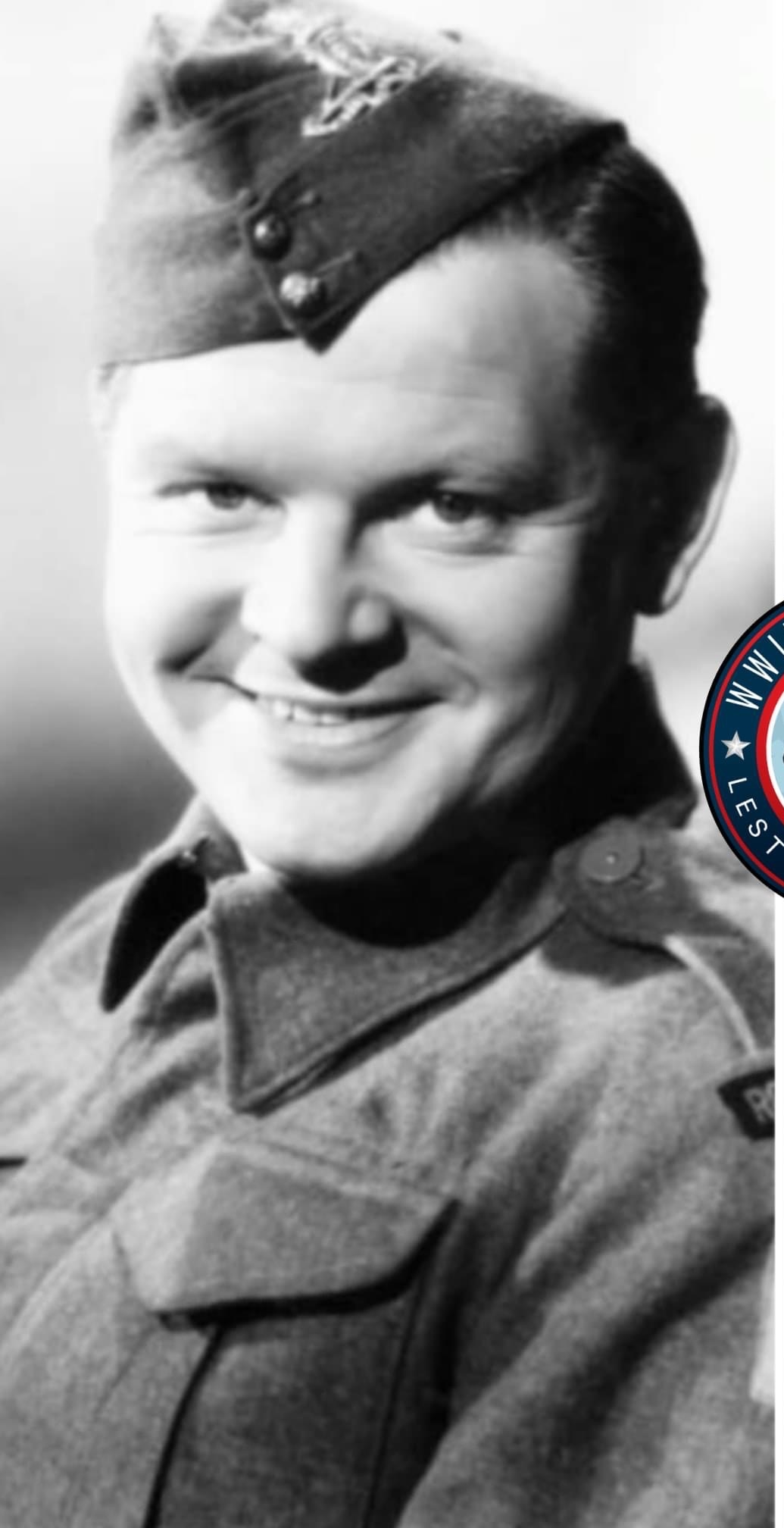 The image is a square photograph of an adult male in military attire, smiling slightly at the camera.