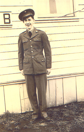 Serviceman standing outdoors in a military dress uniform.