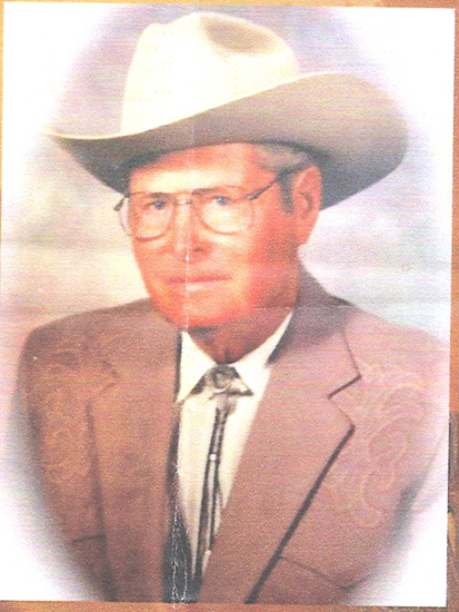 Older man wearing glasses and a cowboy hat in a color portrait.