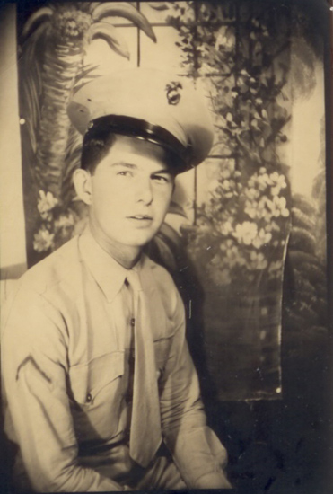 Young serviceman wearing a military cap in a sepia portrait.