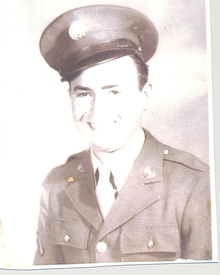 Young serviceman wearing a military uniform and peaked cap.