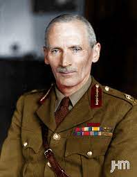 man in military uniform sitting for a photograph.
