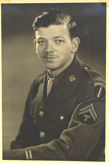 Serviceman wearing a U.S. Army uniform with shoulder insignia.