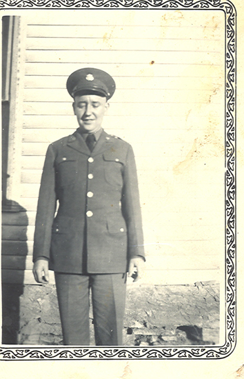 Roger John Bourne standing outside a building in military uniform.