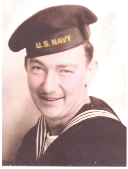 Smiling sailor wearing a U.S. Navy cap.