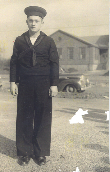 John Brooks Jr. standing outside a building in a dark military uniform.