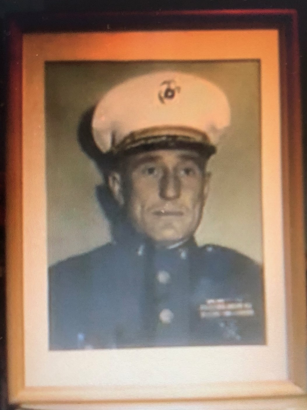 A picture of a person in a military uniform framed.