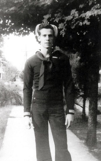 Serviceman standing outdoors in a military uniform.